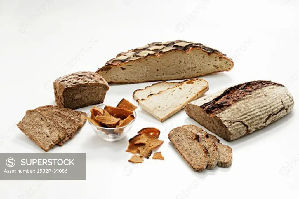Loaves of wood-oven bread, partly sliced, & toasted bread
