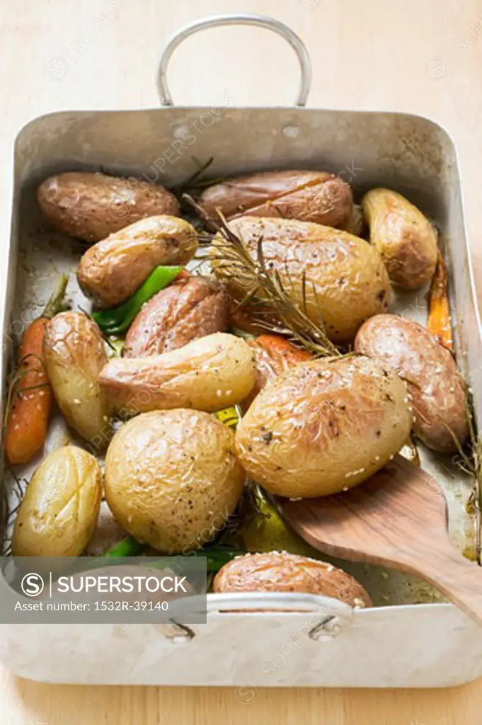 Baked potatoes in roasting tin