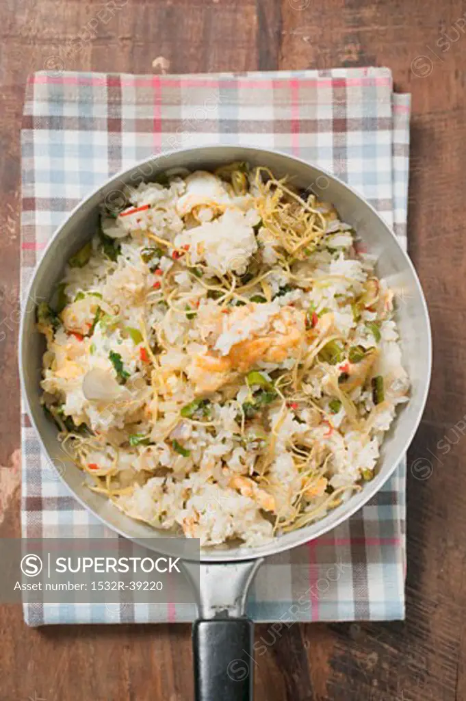 Pan-cooked rice and fish dish with lemon zest from above
