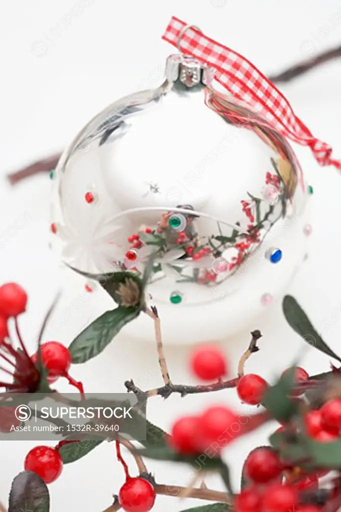 Silver Christmas bauble and berry branch