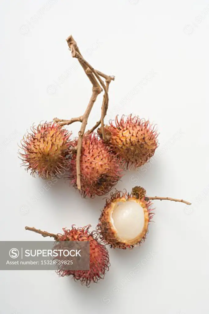 A cluster of three rambutans, two unattached