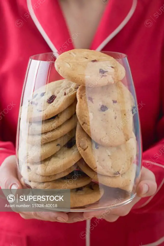 Woman holding glass full of cranberry cookies