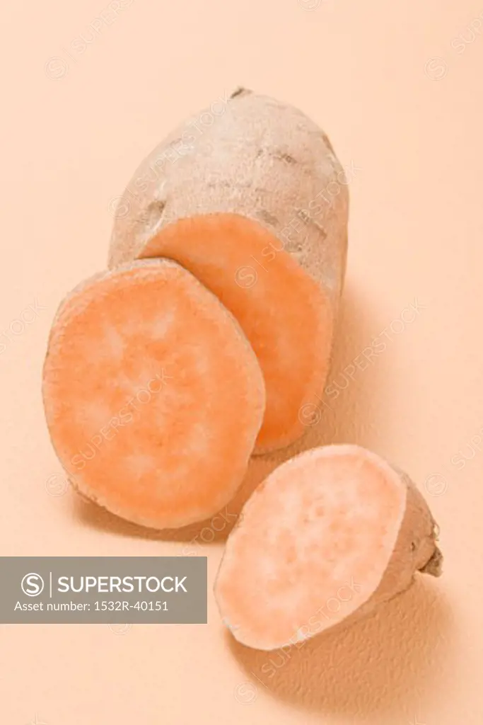 A sweet potato, partly sliced
