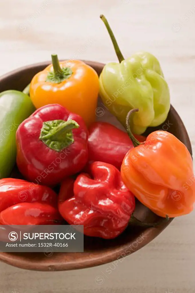 Mixed peppers and chillies in wooden dish
