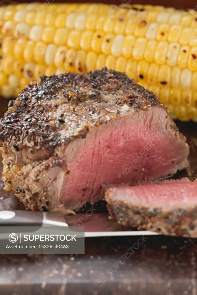 Peppered steak with corn on the cob