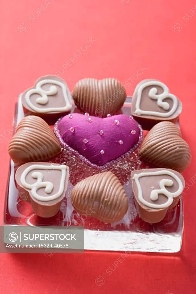 Purple fabric heart surrounded by chocolates