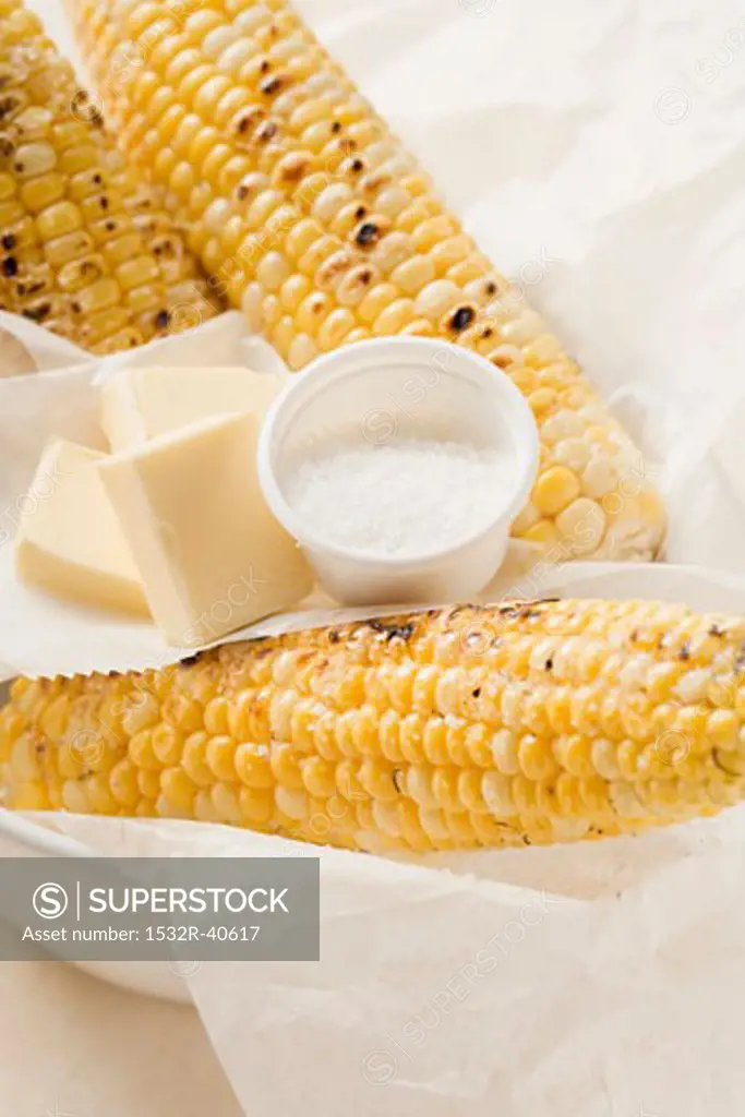Grilled corn on the cob with salt and pieces of butter