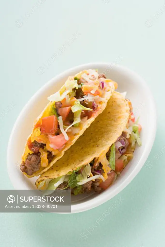 Two mince tacos in white dish