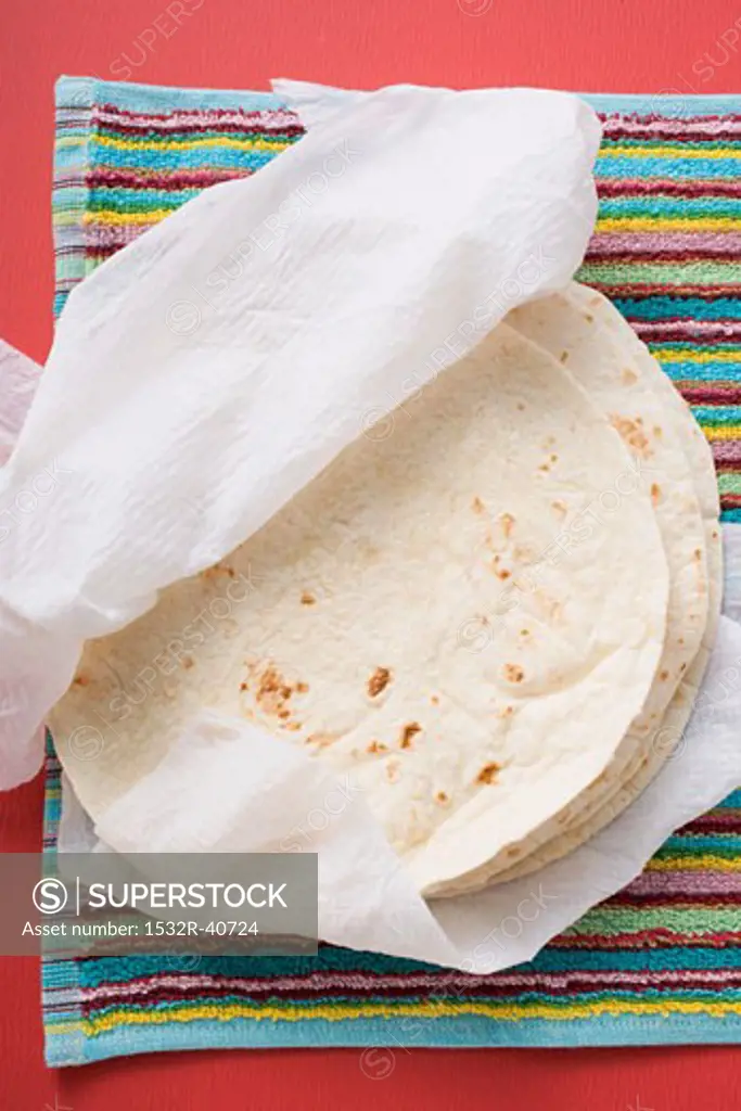 Freshly-baked tortillas on kitchen roll (Mexico)