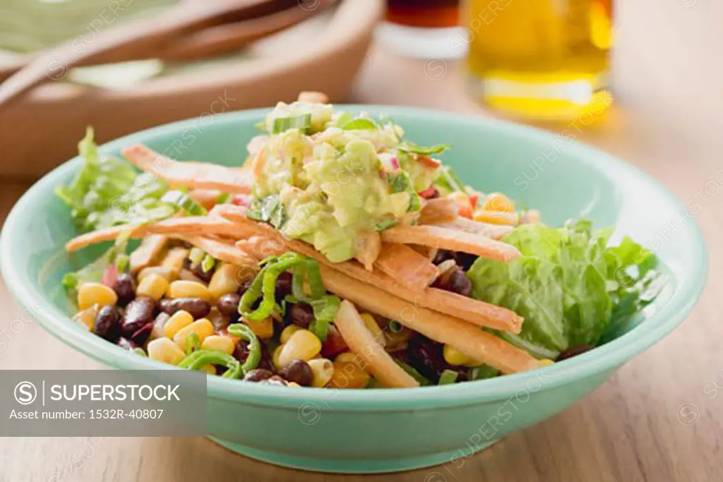 Lettuce, beans, sweetcorn, tortilla strips and guacamole