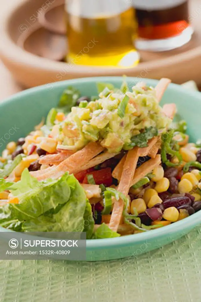 Lettuce, beans, sweetcorn, tortilla strips and guacamole