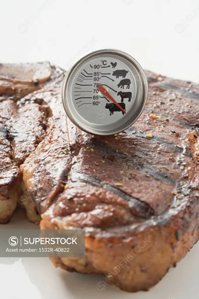 Grilled T-bone steak with meat thermometer