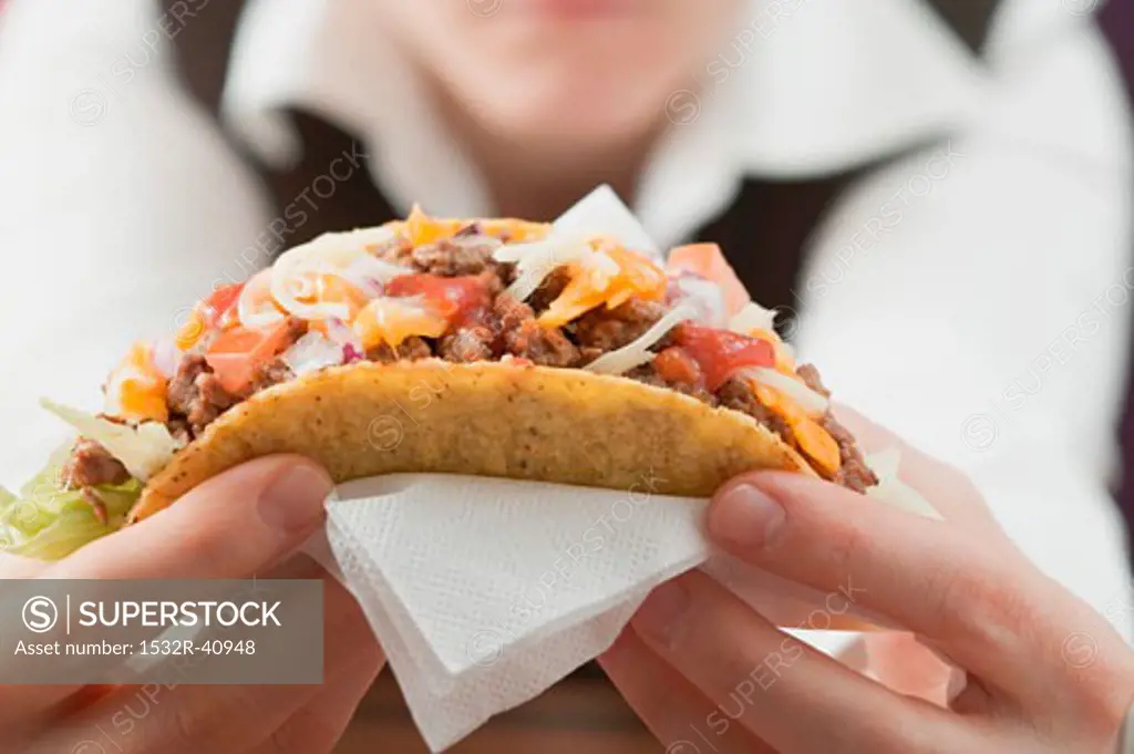 Woman holding mince taco