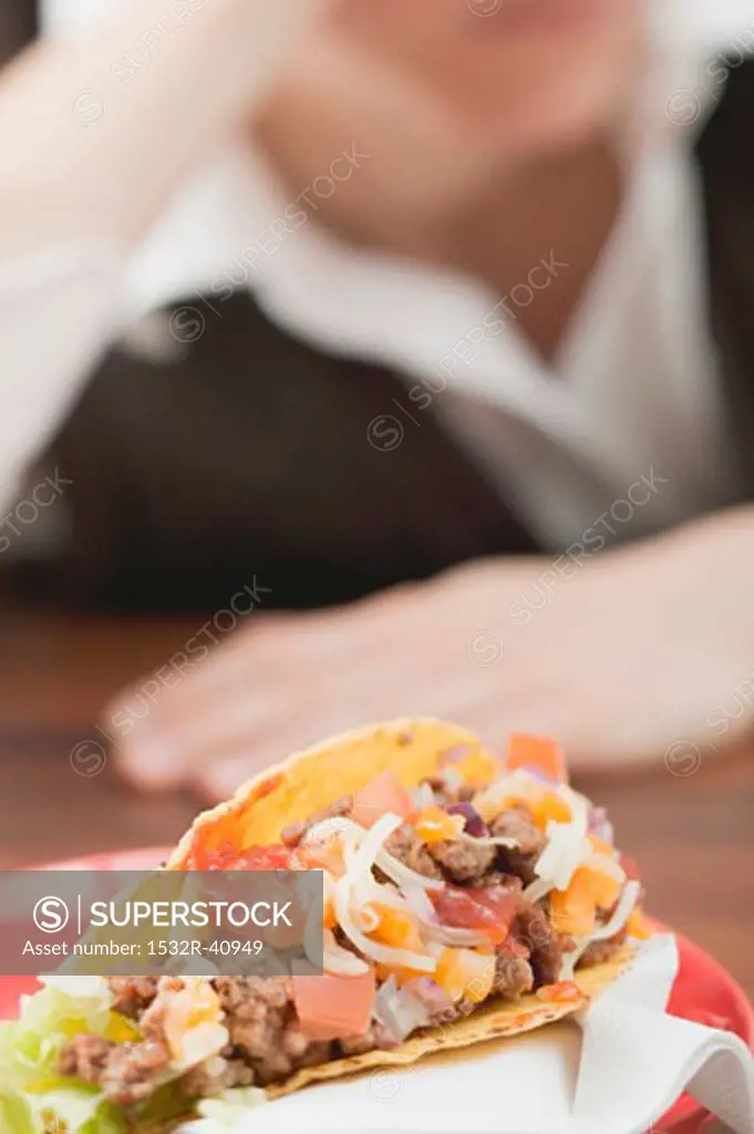 Mince taco, woman in background