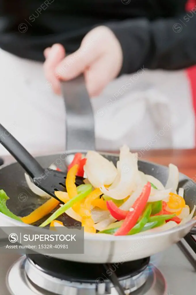 Sautéing vegetables in frying pan
