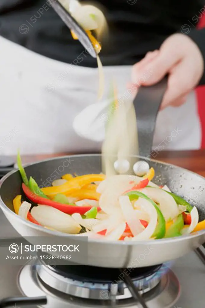 Sautéing vegetables in frying pan
