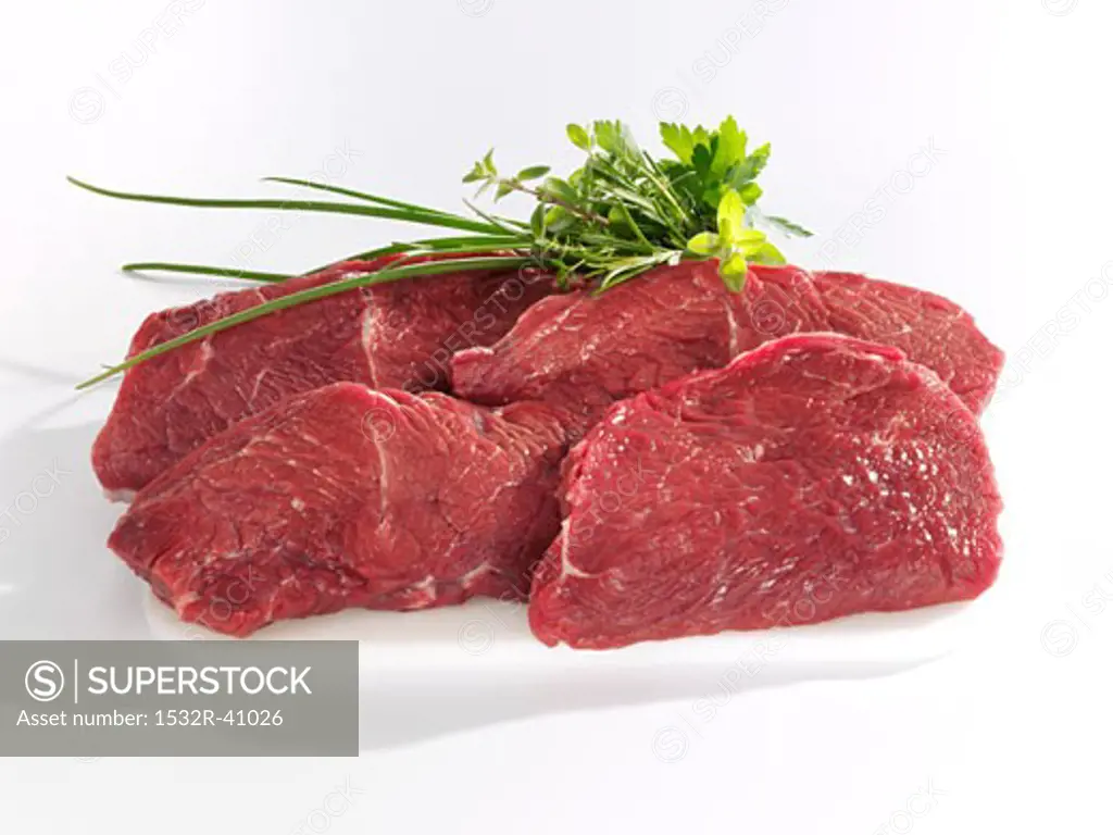 Rump steaks with small bunch of herbs