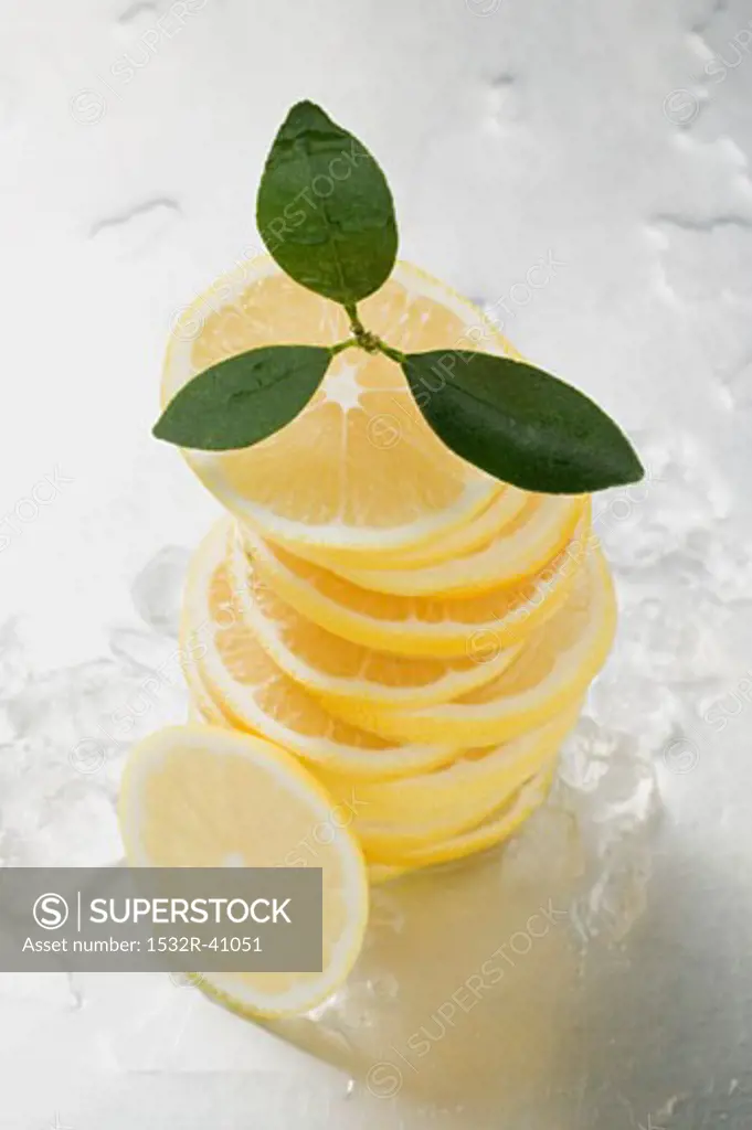 Lemon slices, stacked, surrounded by ice cubes