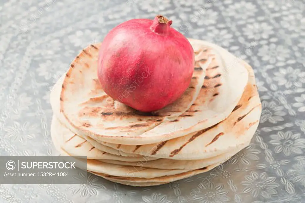 Pomegranate on a stack of flatbread