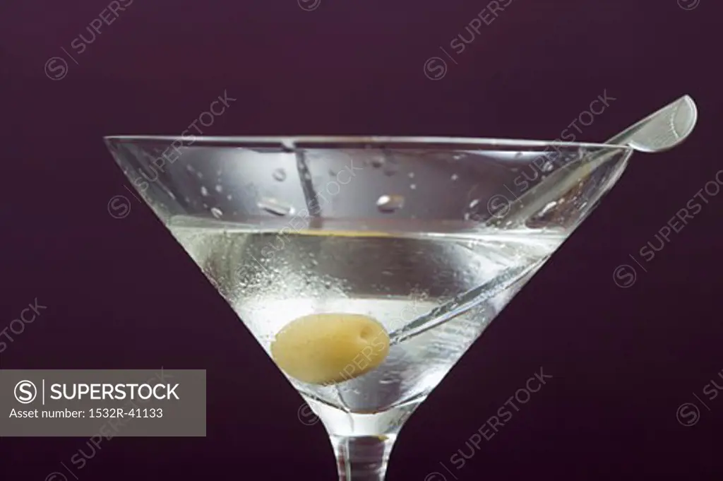 Martini with olive in glass
