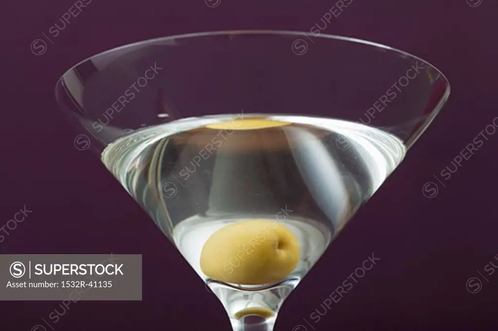 Martini with olive in glass