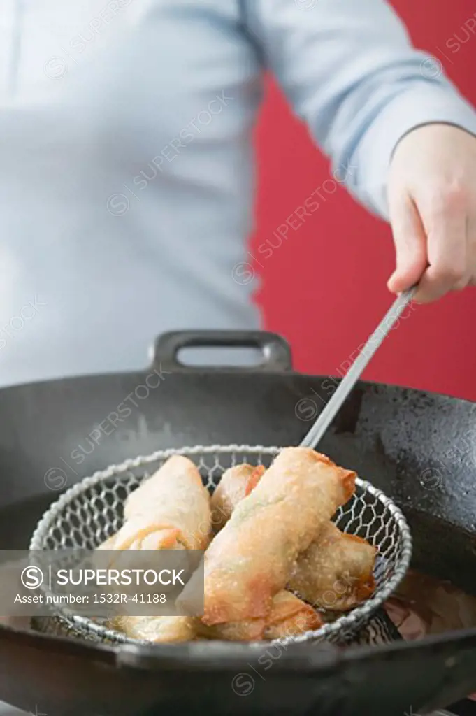 Deep-frying spring rolls in wok