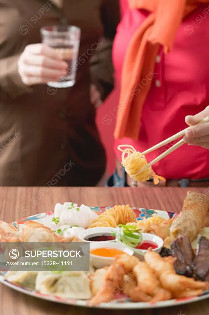 Two women with Asian appetiser platter