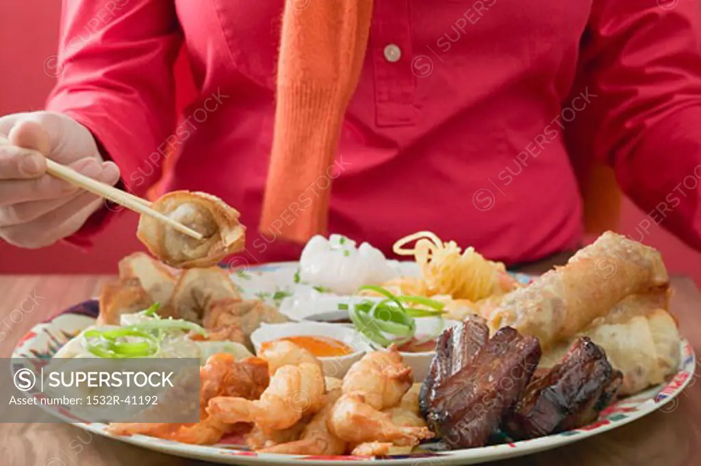 Woman eating Asian appetisers