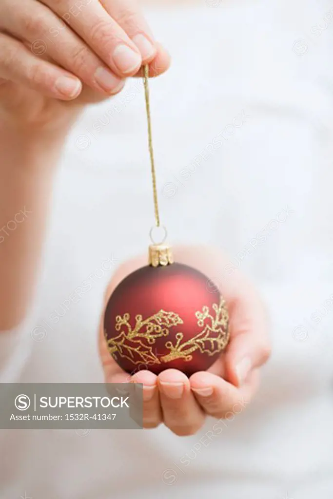 Hands holding Christmas bauble