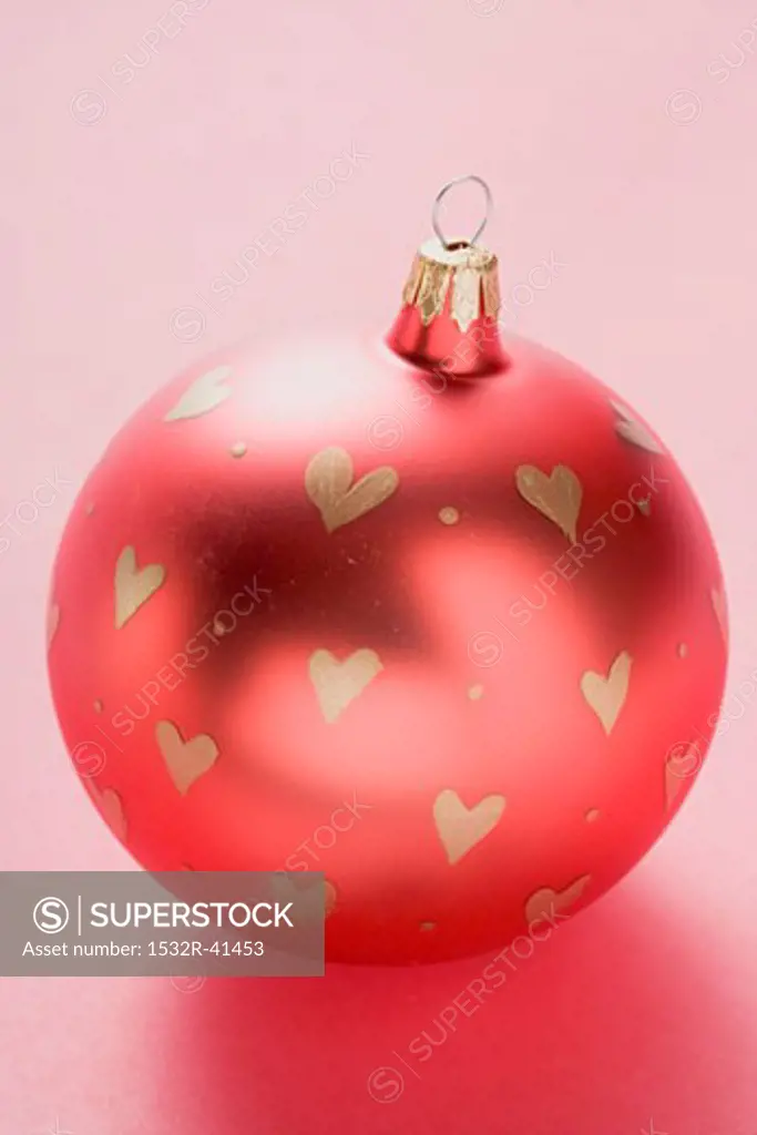 Red Christmas bauble with painted hearts