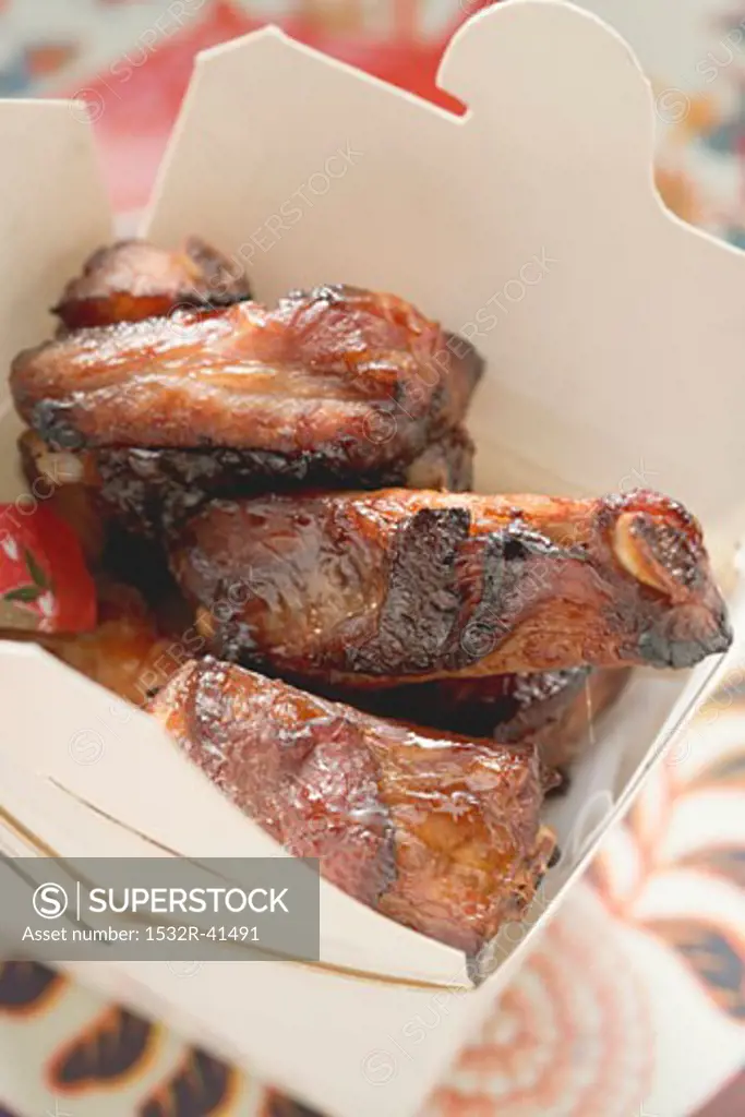 Crispy fried pork ribs in take-away container