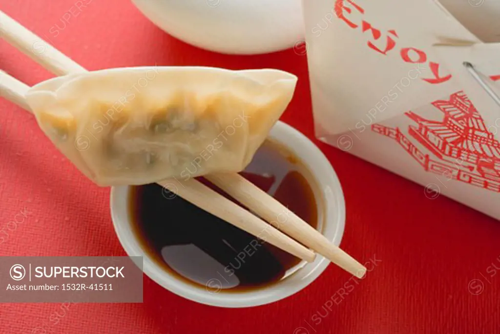 Dim sum with chopsticks and dip to take away (Asia)