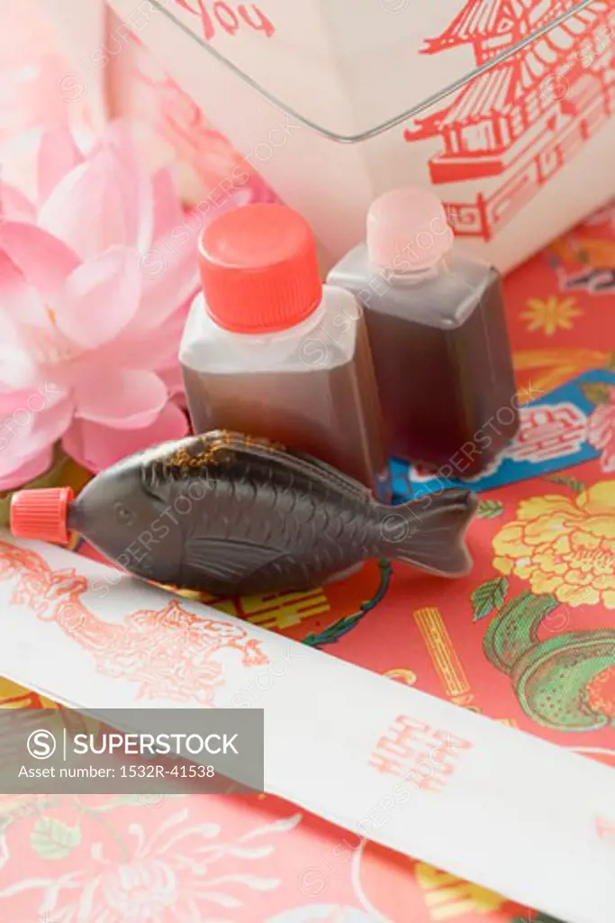 Soy sauce, chopsticks and take-away container (Asia)