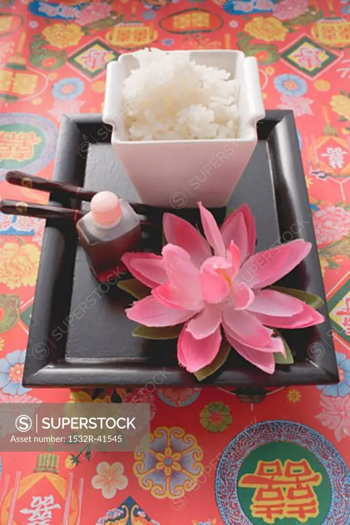 Rice, soy sauce and chopsticks on tray (Asia)
