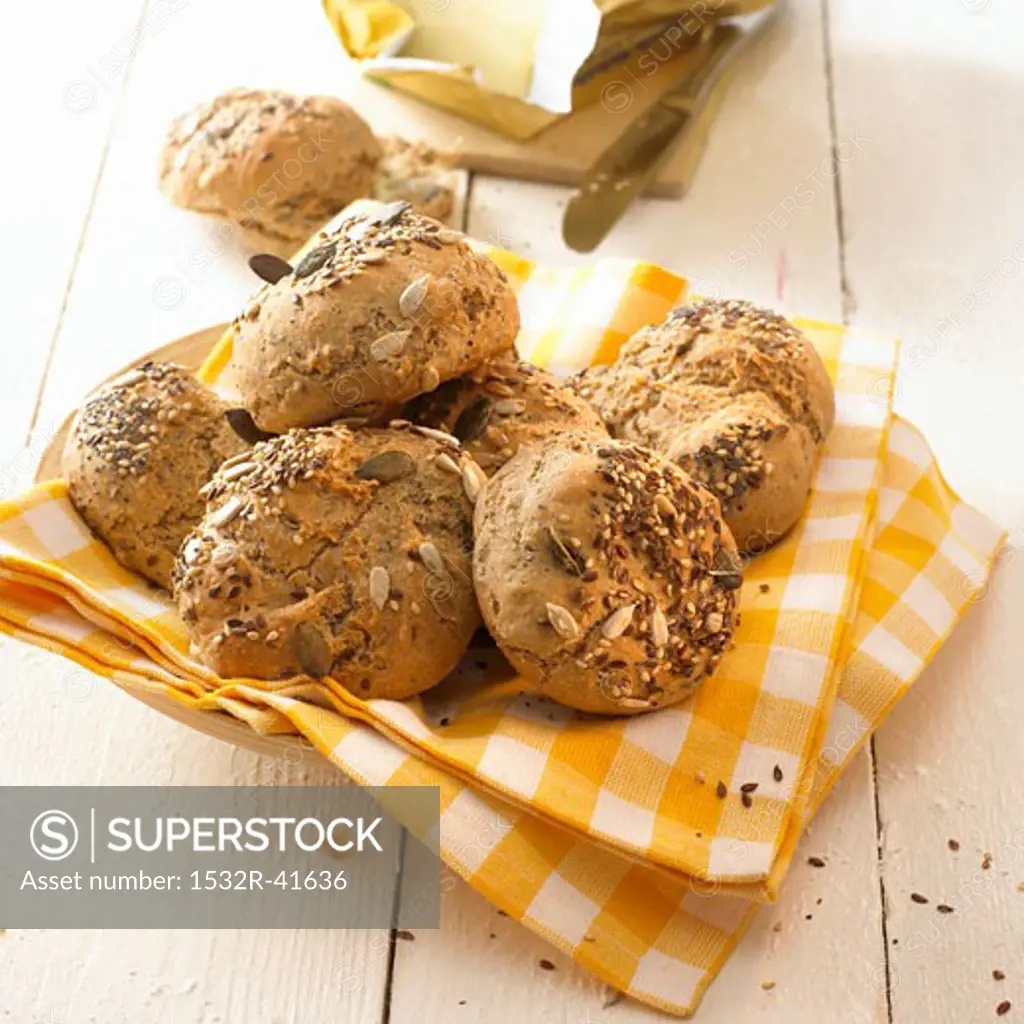 Mixed seed bread rolls on a checked cloth