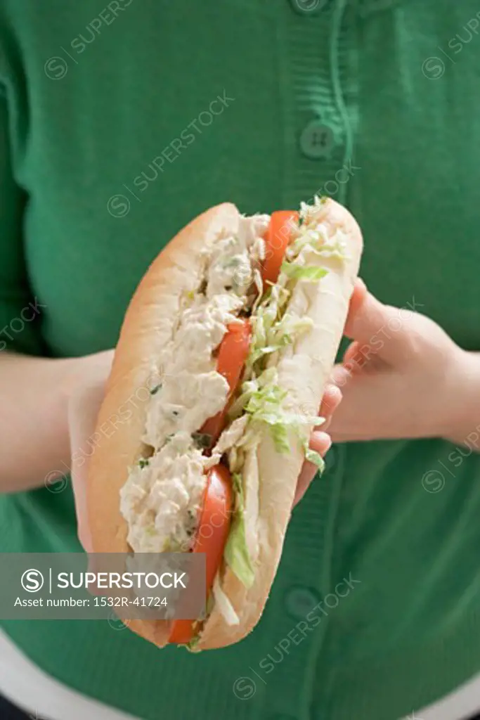 Woman holding chicken sandwich