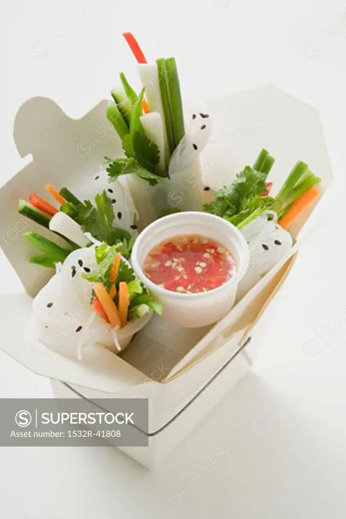 Rice paper rolls with vegetables & sauce in take-away container