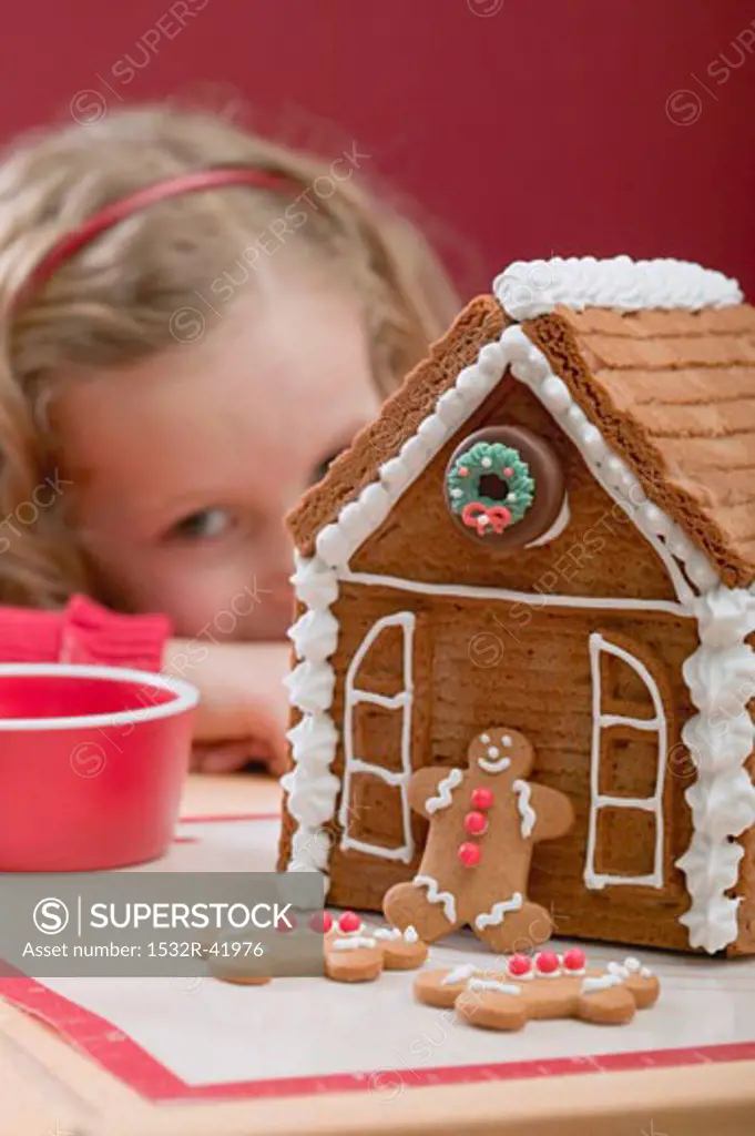 Gingerbread house, small girl in background