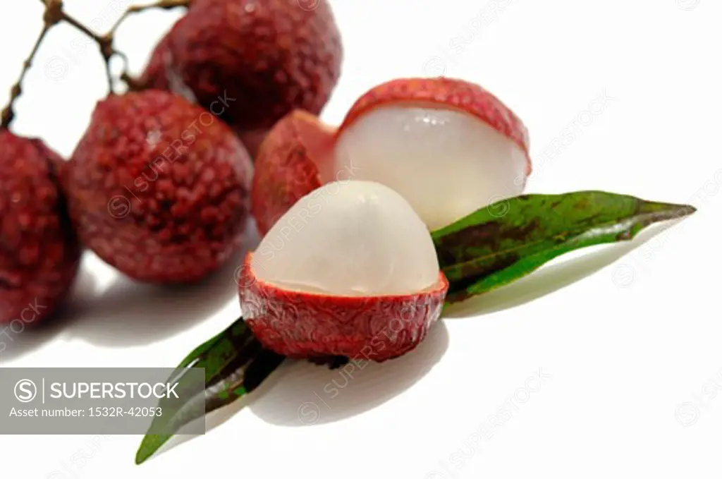 Several lychees, one cut open