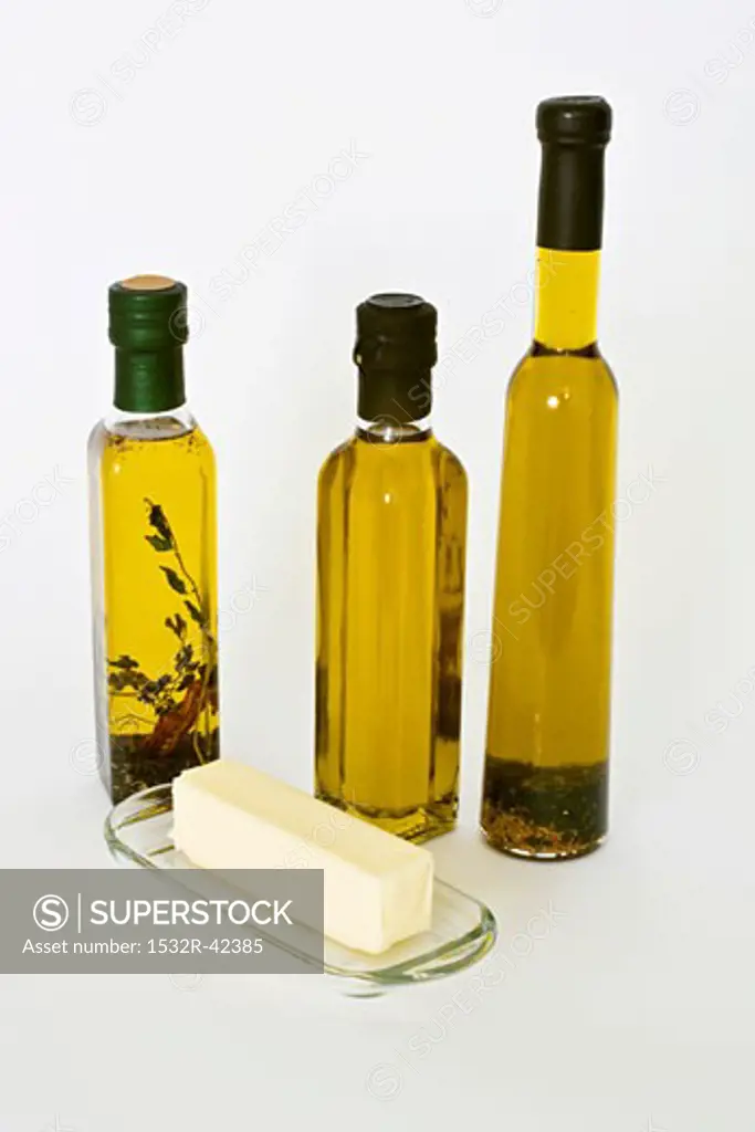 Three Assorted Bottles of Olive Oil; Butter