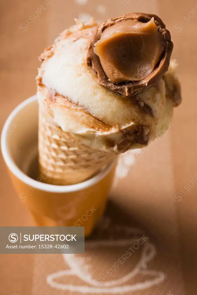 Caramel ice cream in wafer cone in a beaker
