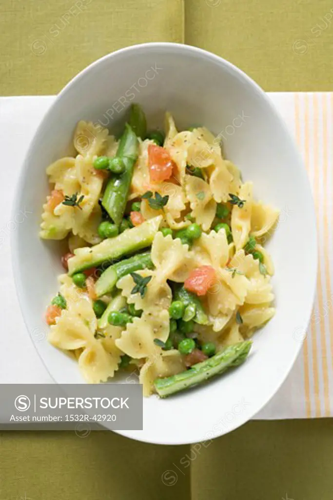 Farfalle with green asparagus, peas and diced tomatoes