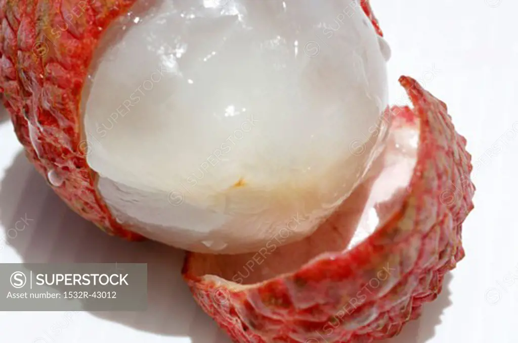 A half-peeled lychee