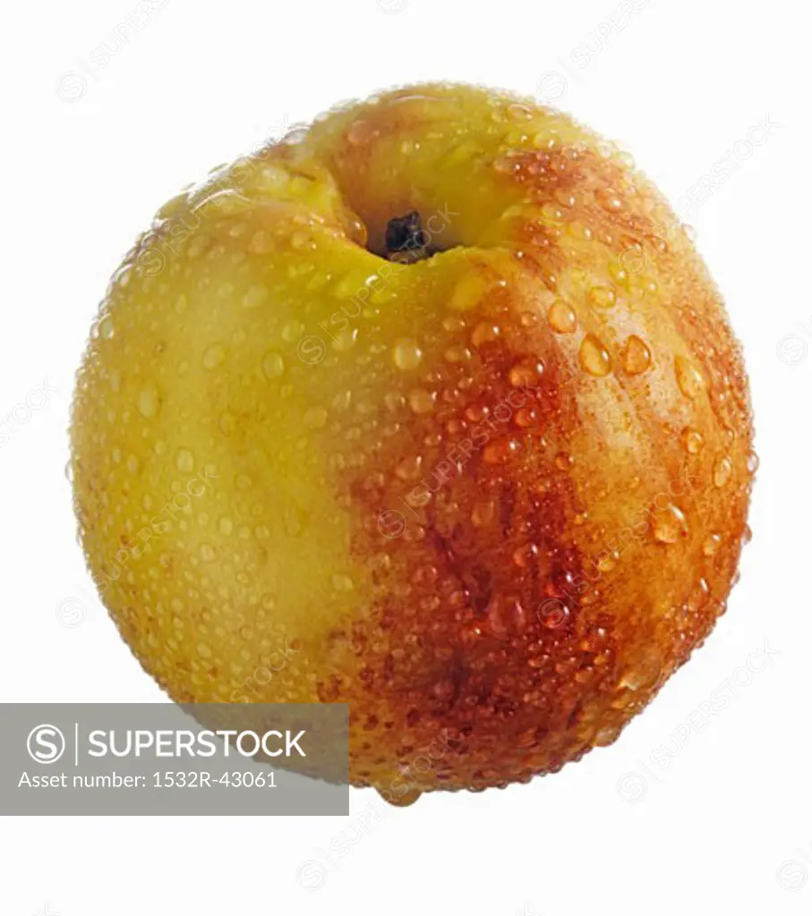 A nectarine with drops of water