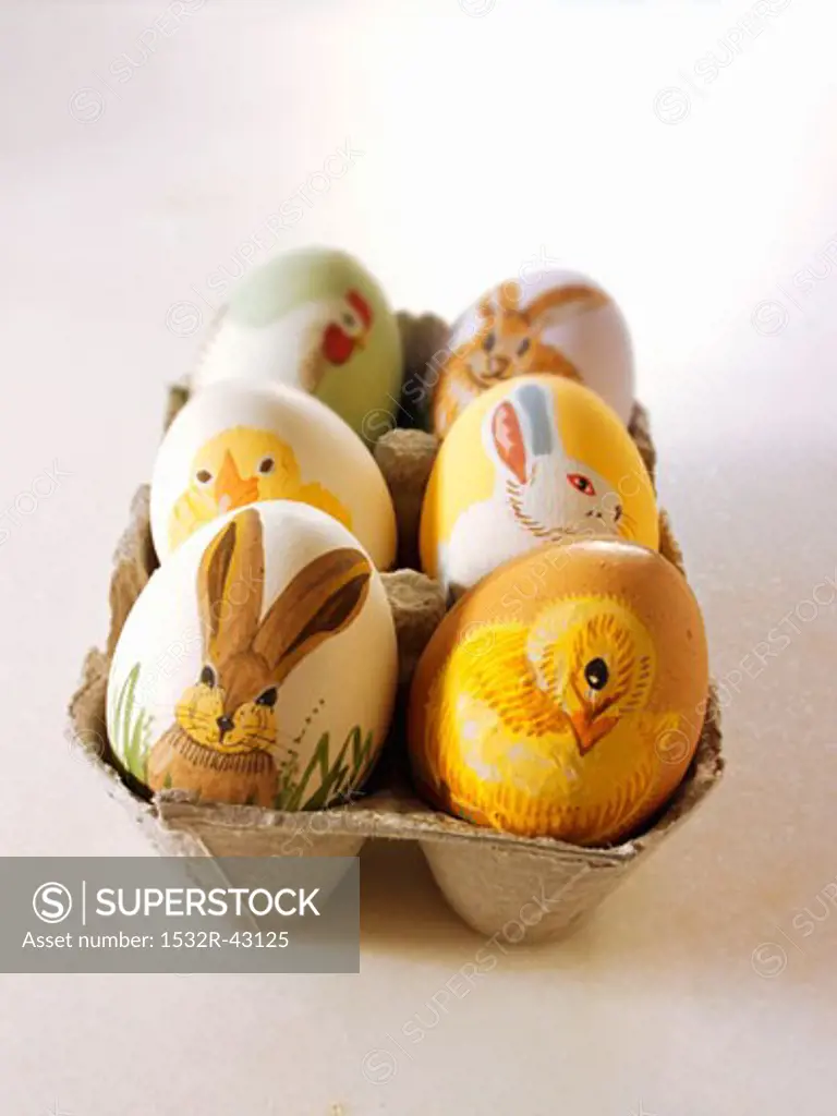 Easter eggs painted with animal motifs in egg box
