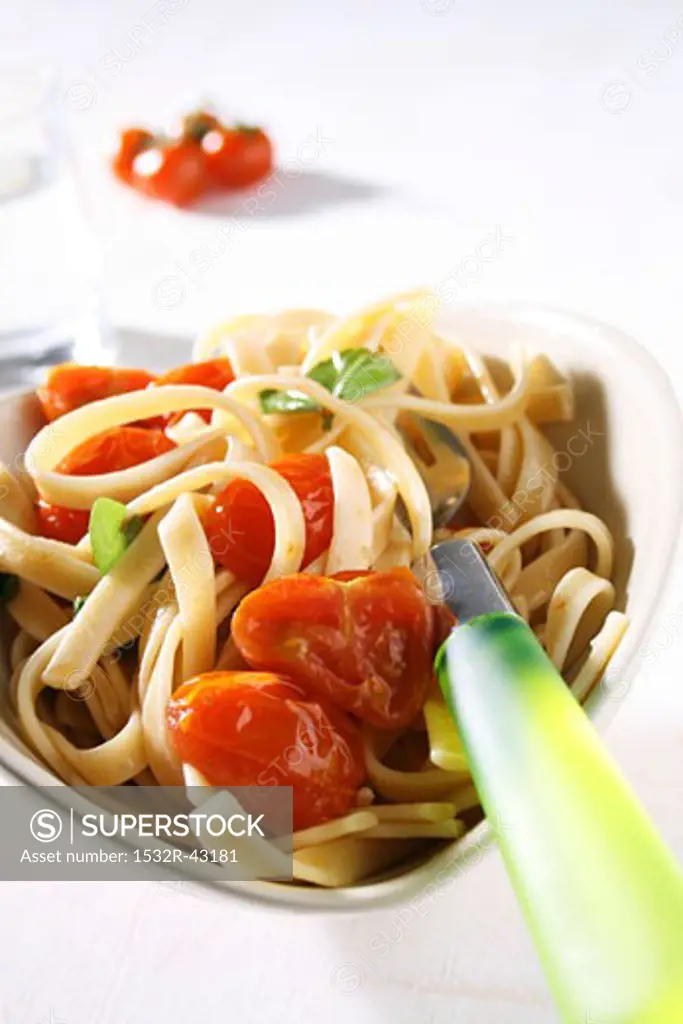Linguine with cherry tomatoes in heart-shaped dish