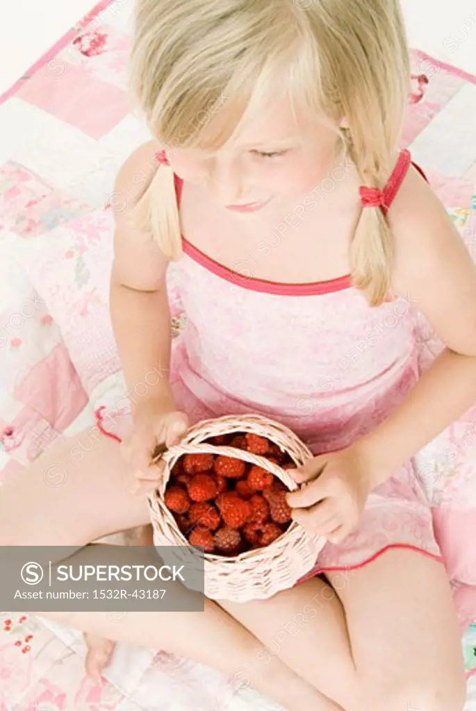 Blond girl with fresh raspberries (from above)