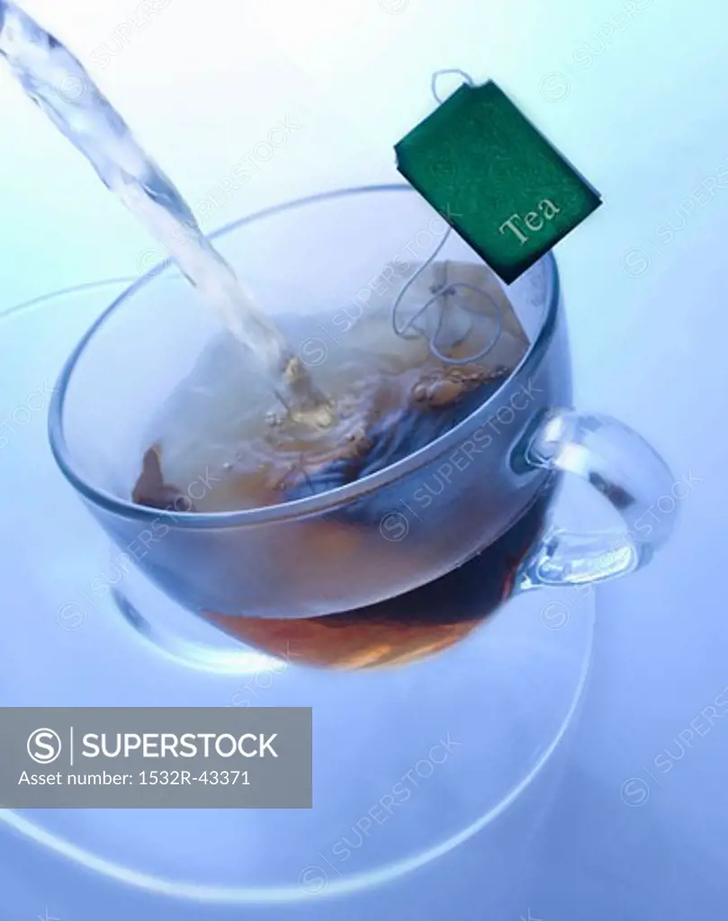 Pouring boiling water onto tea bag