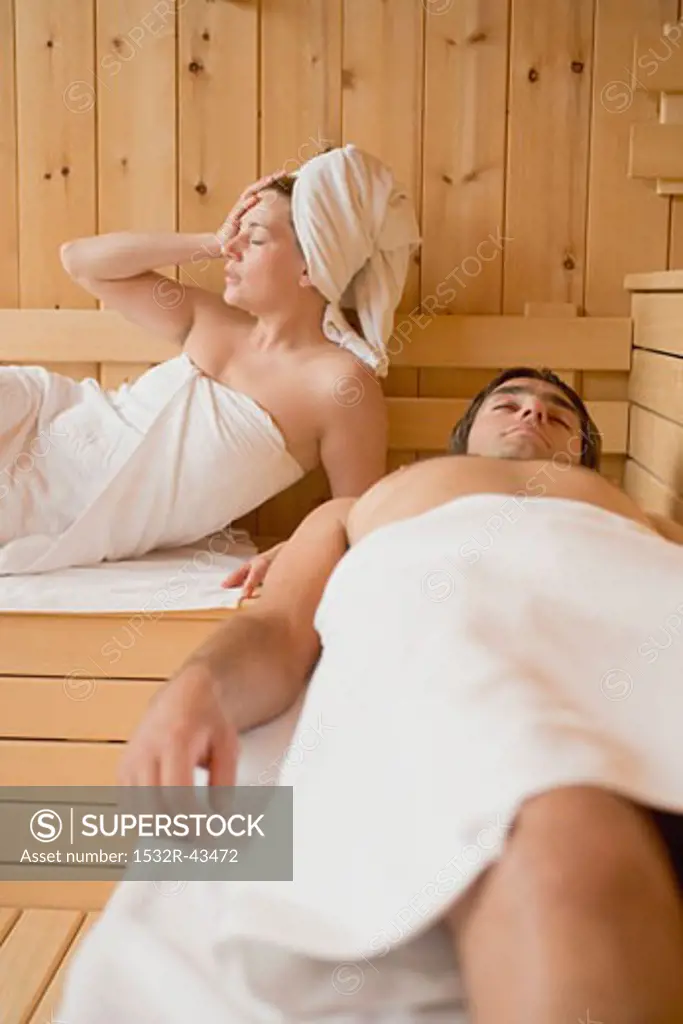 Man and woman lying in a sauna