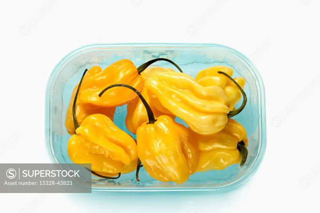 Yellow habanero chillies in a plastic tray